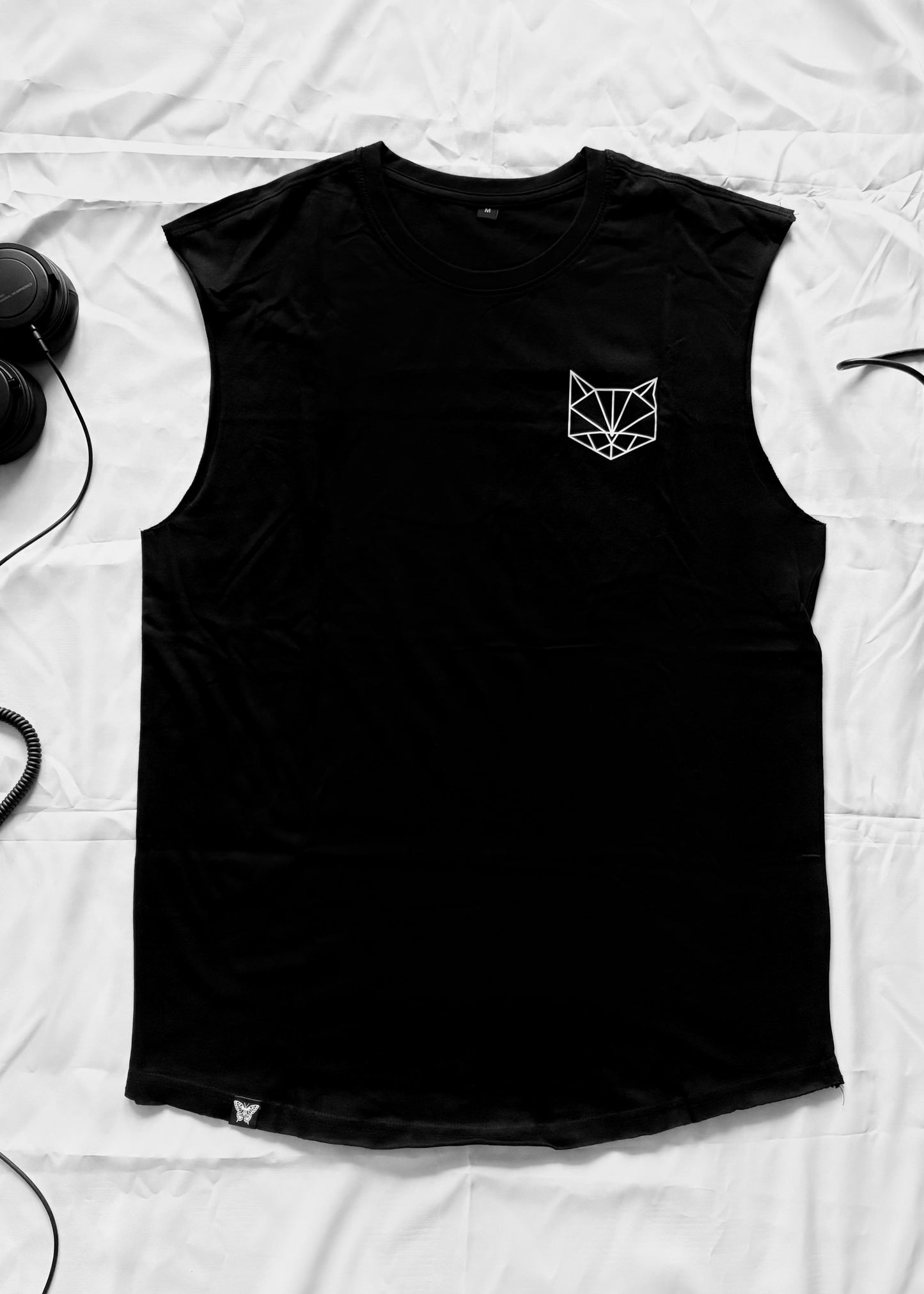 Black cotton tank top with a minimalist front featuring a small cat logo on the chest and a hand-sewn PAPAGE label near the hem. The back shows a large geometric cat design printed in white using high-quality screen printing. The fit is oversized with dropped shoulders and a crew neck.